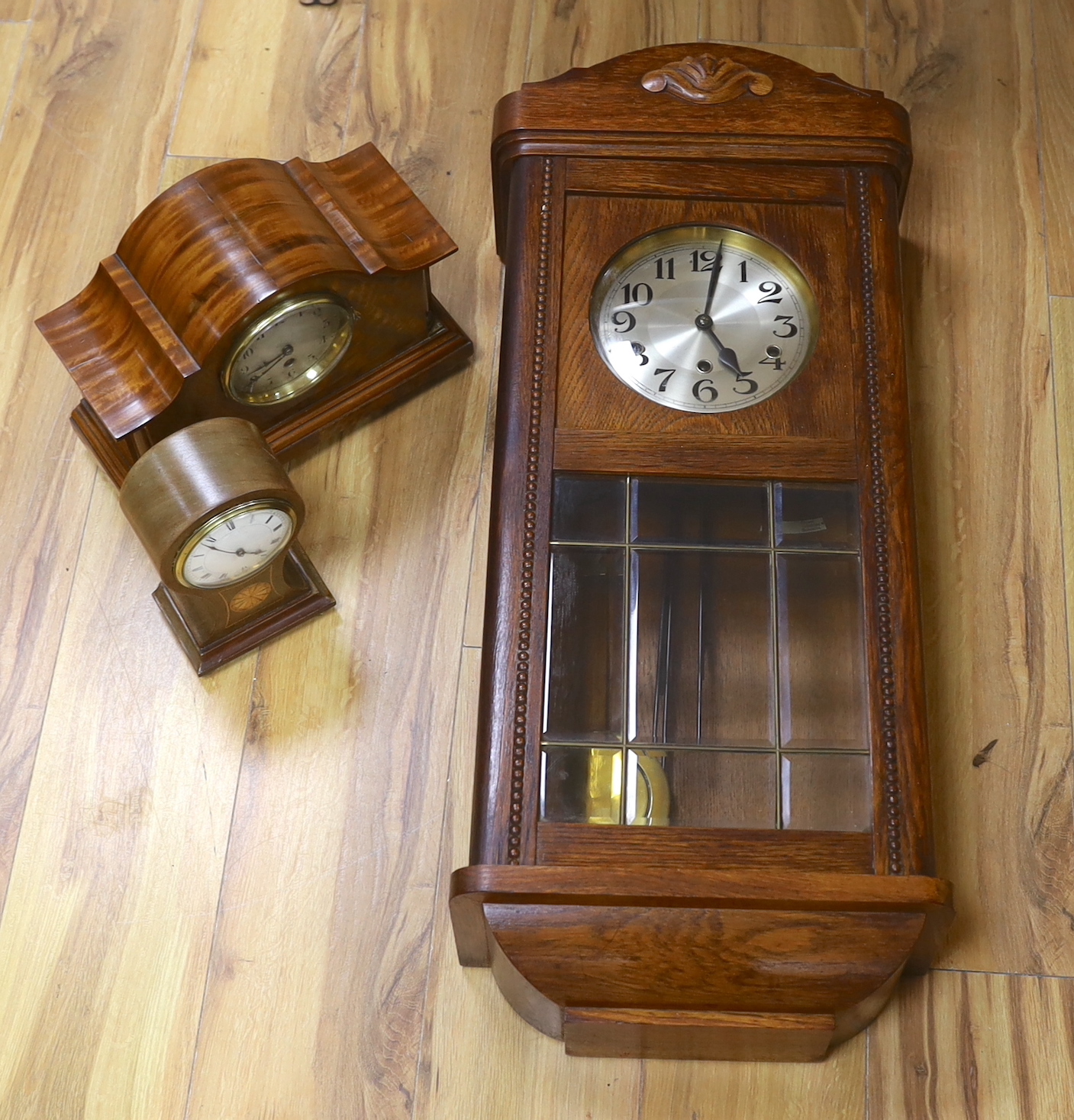 Two mantel clocks including an Edwardian inlaid balloon example and a wall clock, largest 80cm high